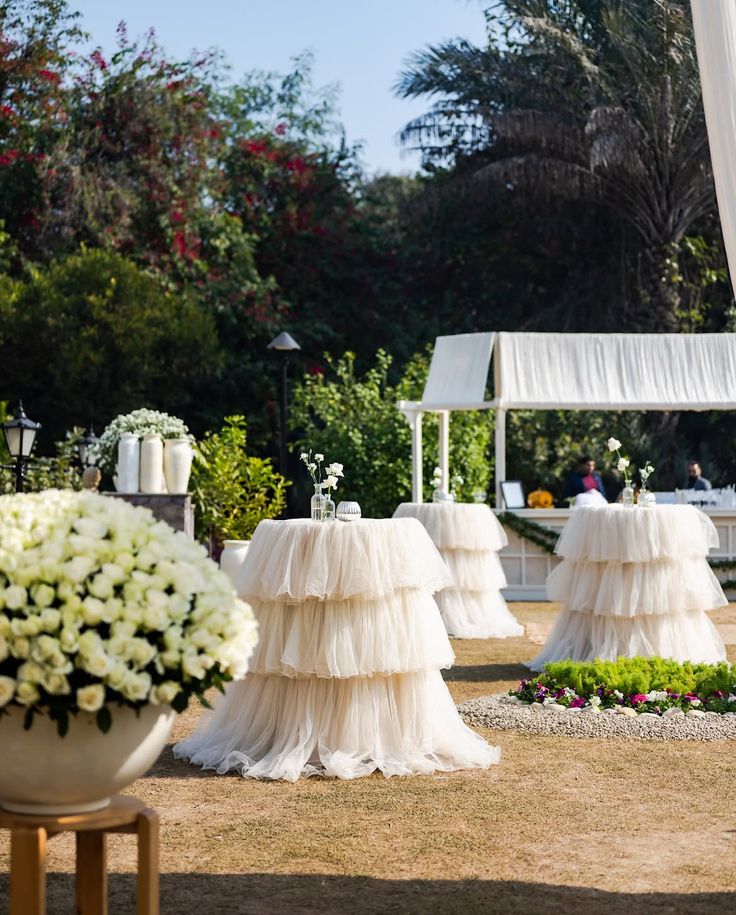 Tulle-draped garden cocktail tables with white roses