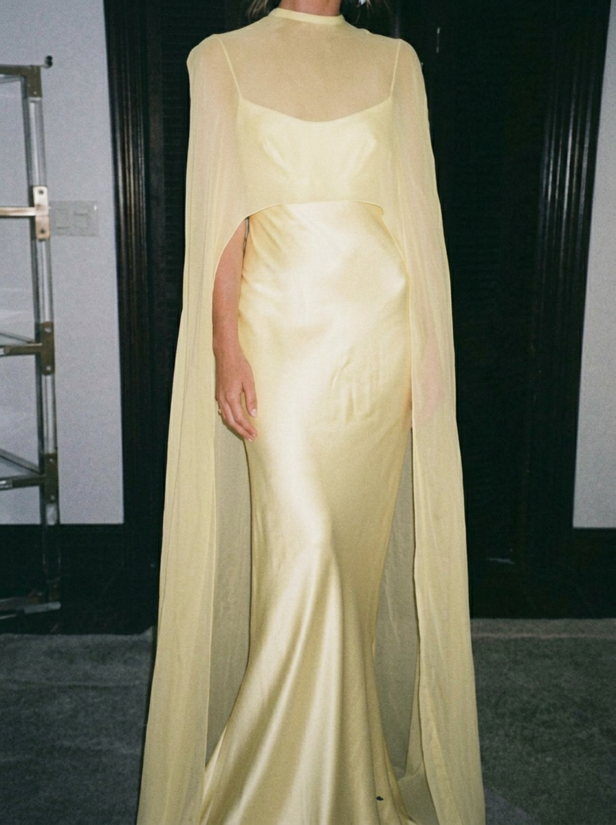 Pastel yellow satin gown with chiffon cape