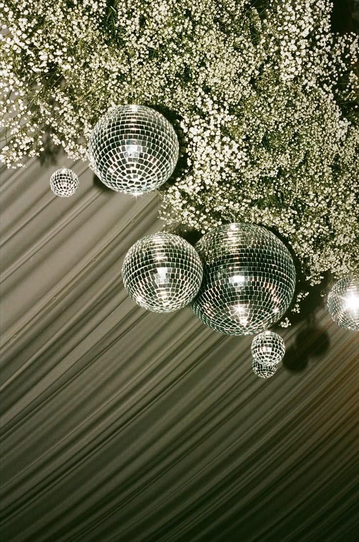 Disco balls suspended in baby's breath floral installation